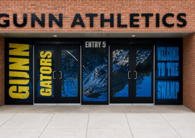 Custom Gunn Athletics entrance window graphics featuring Gators school branding